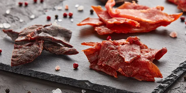 Three small piles of beef jerky